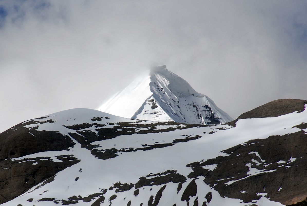 60 Mount Kailash South, East and North Faces From The Eastern Valley On Mount Kailash Outer Kora About 30 minutes from the end of the descent from the Dolma La, a valley comes down from the Khando Sanglam La to join the main trail. This valley provides the only glimpse of the Eastern or crystal Face of Mount Kailash. The Kailash South Face is to the left and the North Face is to the right.